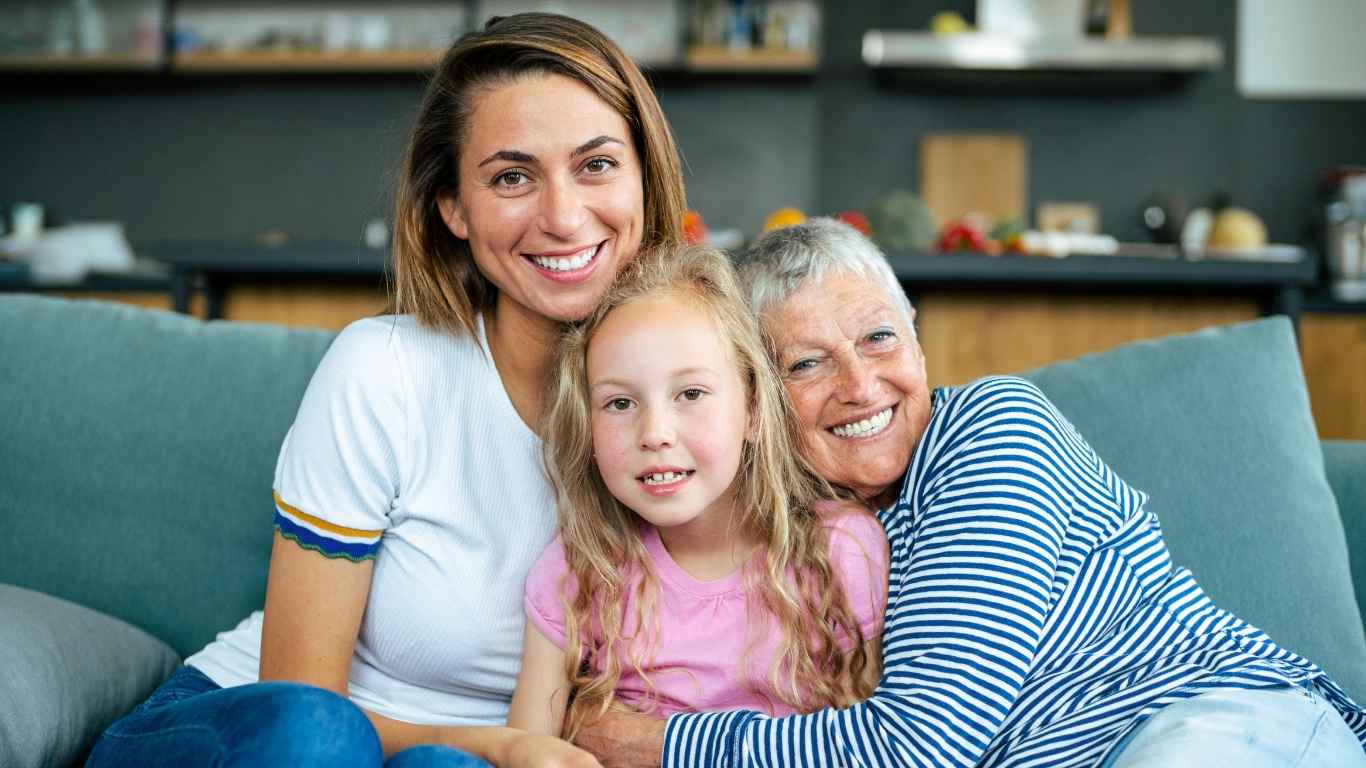 Parents discussing property plans with their adult children outside a home, representing equity release helping children buy their first home